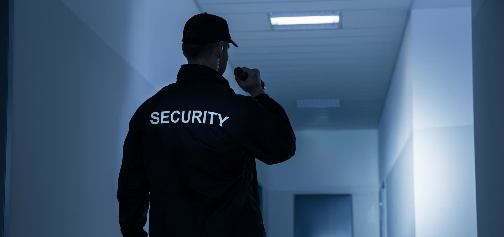 A security worker holding a torch